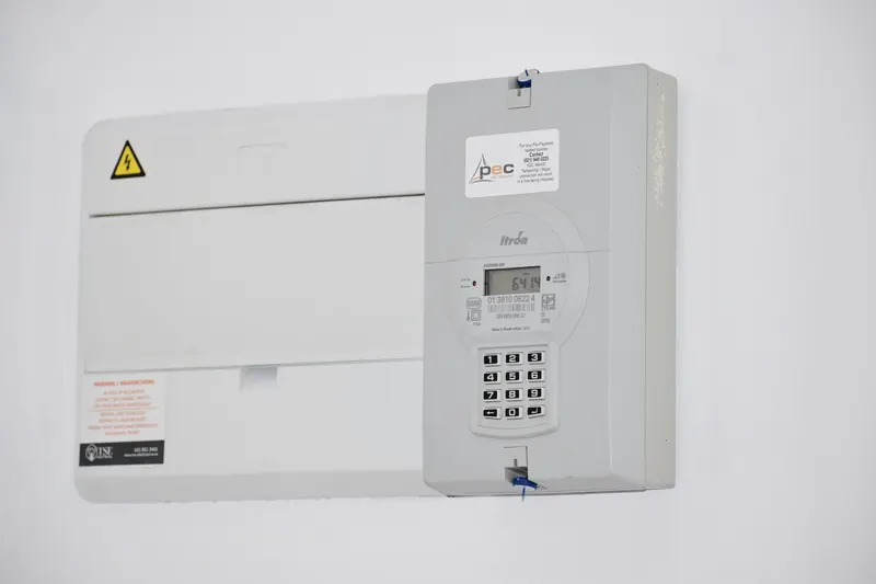 Electrical meter and fuse box on a white wall in Cape Town, South Africa, for energy monitoring or billing