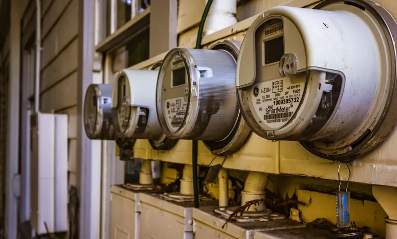 Image of multiple smart electricity meters installed on a residential exterior wall, showing environmental adaptation